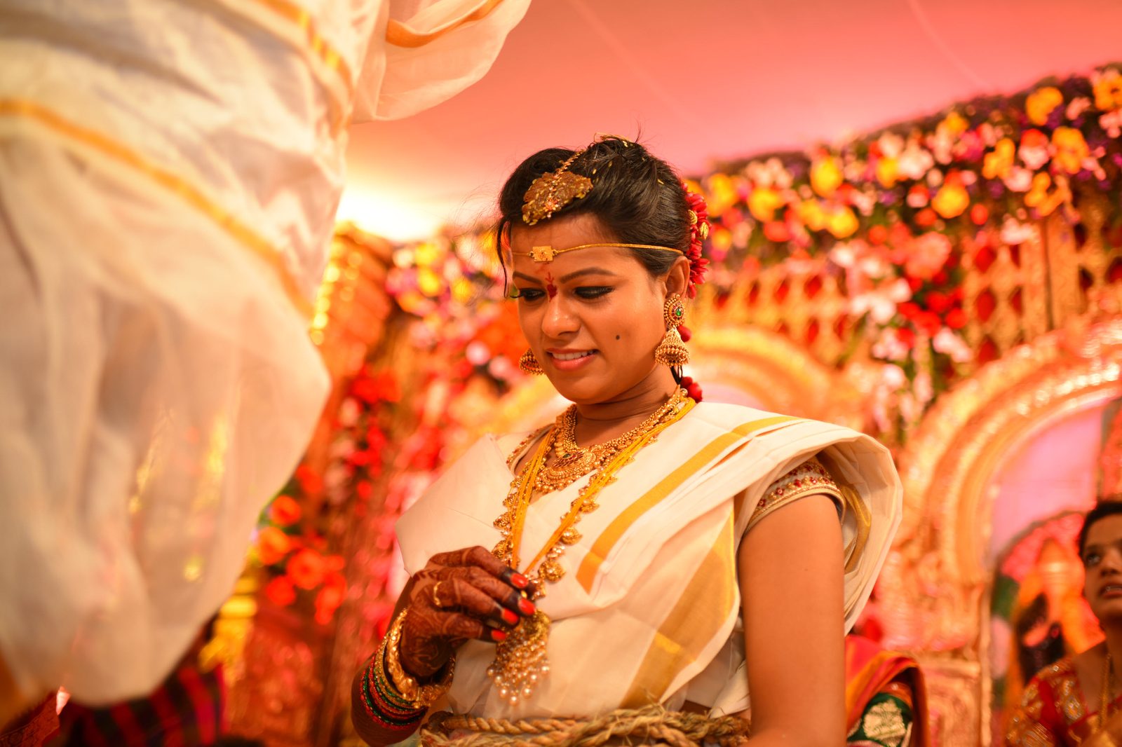 Bride at a floral wedding mandap, styled by SminkUp